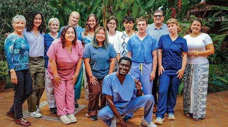 a group of Costa Rica summer program students pose outside the center